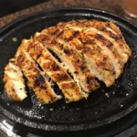 Perfectly seared chicken breast strips cooked on a Blackstone griddle, seasoned with garlic, paprika, and lemon.