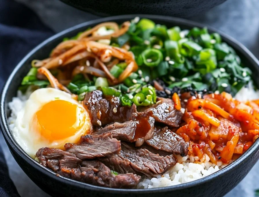 Delicious Korean BBQ steak rice bowl garnished with vegetables.